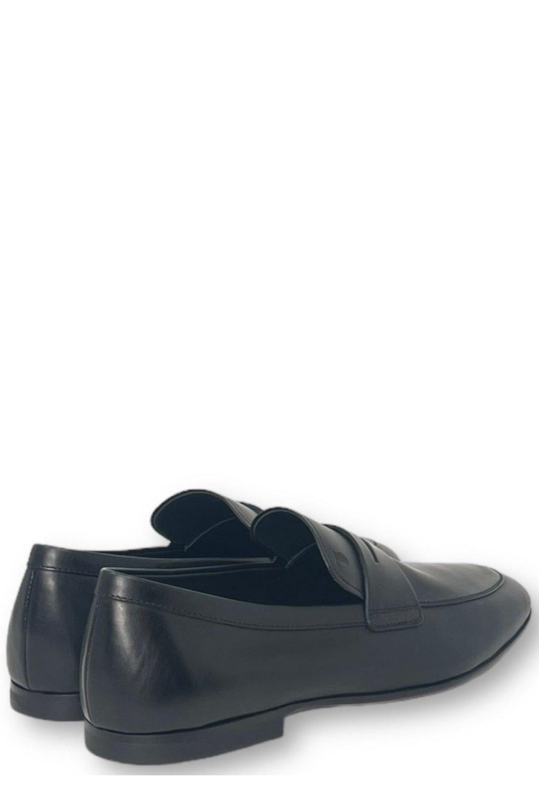 Shop Tod's Logo-embossed Slip-on Loafers In Black