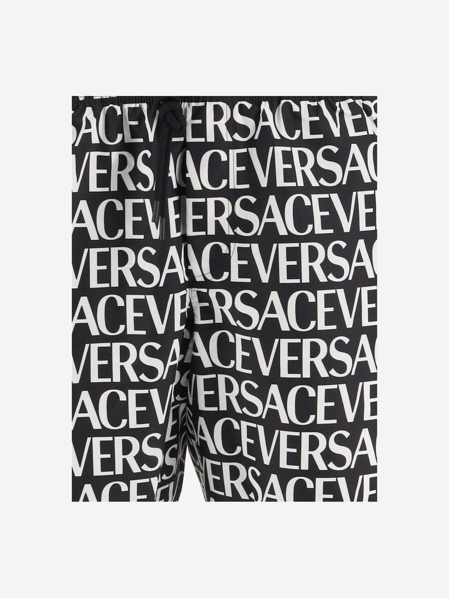 Shop Versace All-over Logo Print Swimsuit In Red