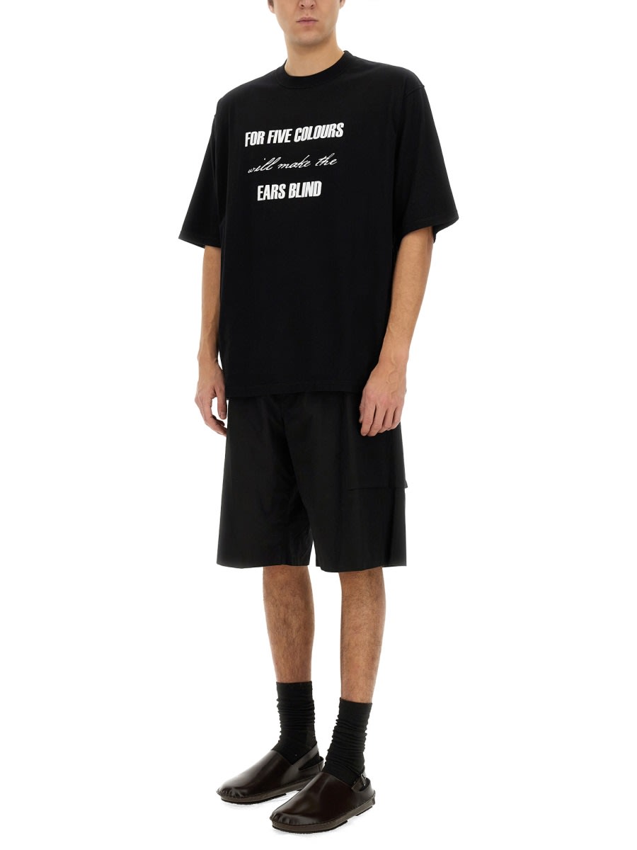 Undercover Graphic Print Black T-shirt With Exposed-seam Detailing And Logo Patch In Black